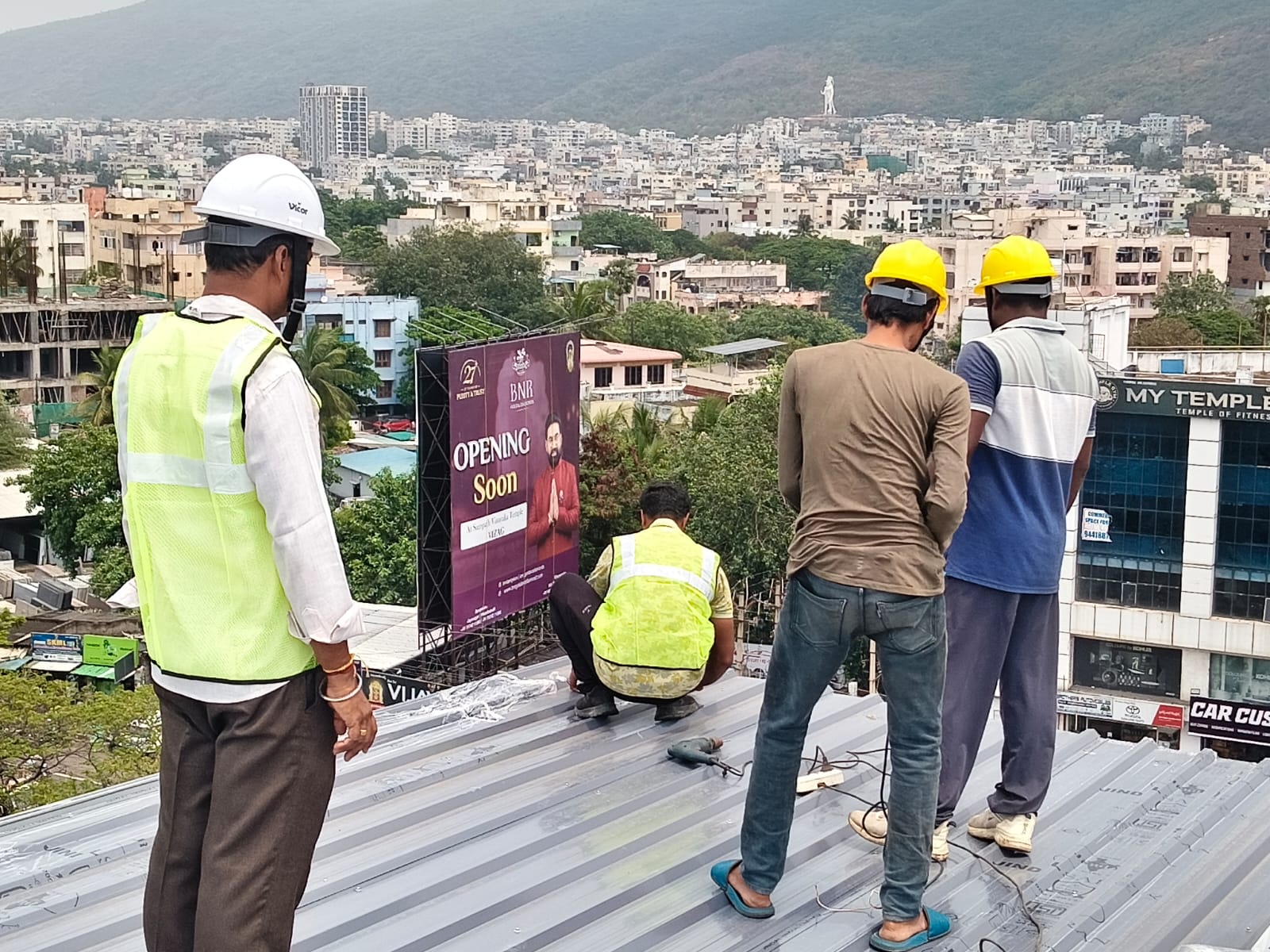 Site supervisor and crew on a rooftop during solar mounting structure installation