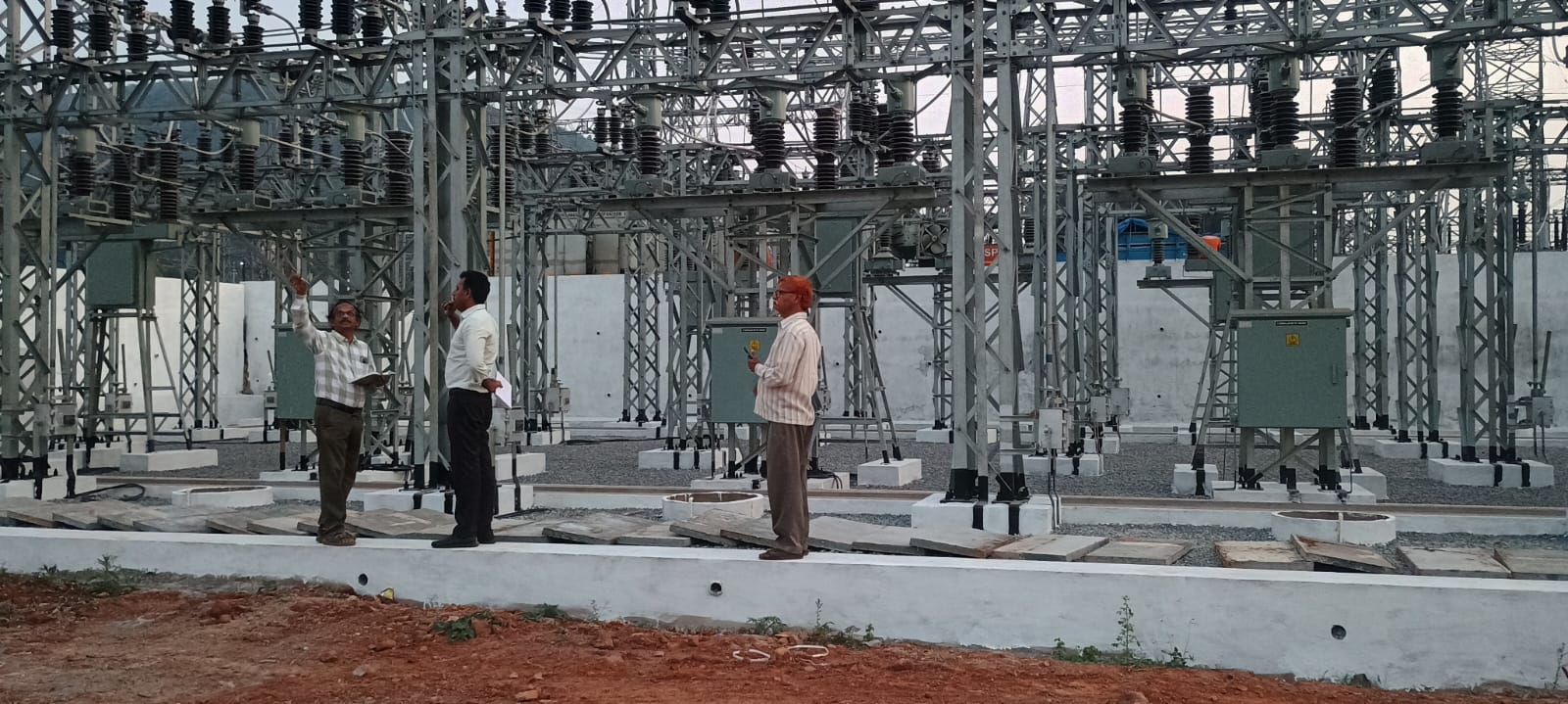 Engineers inspecting switchgear yard at a newly built substation