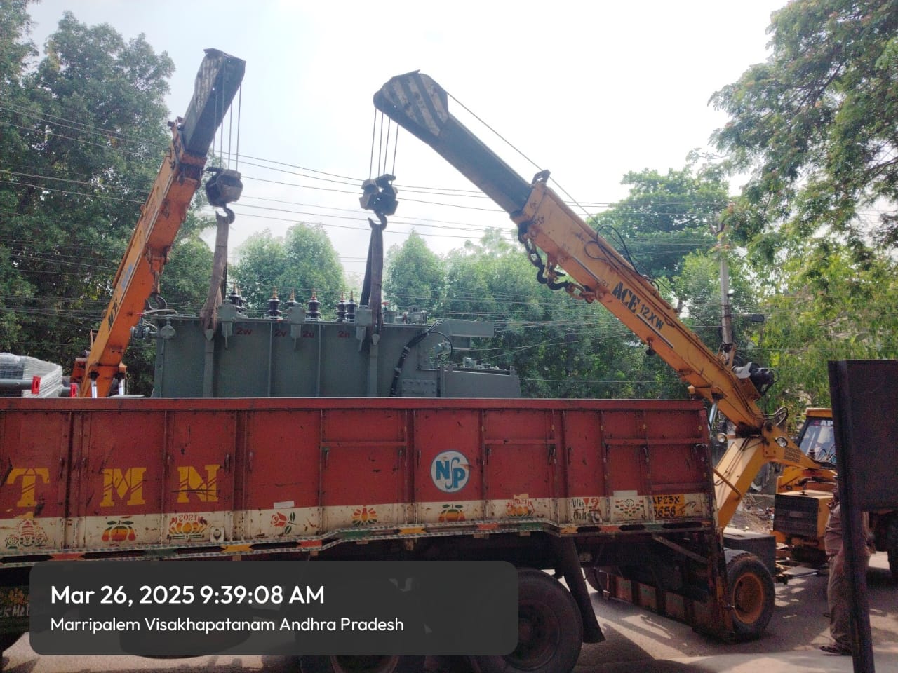 Crane lifting a power transformer off a truck on site, dated March 26 2025, Marripalem Visakhapatnam